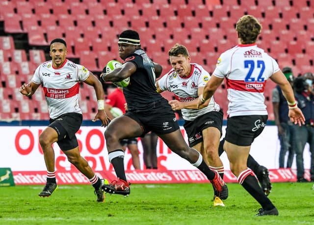 Ntuthuko Mchunu of the Sharks on his way to score a try after which he celebrated with teammates